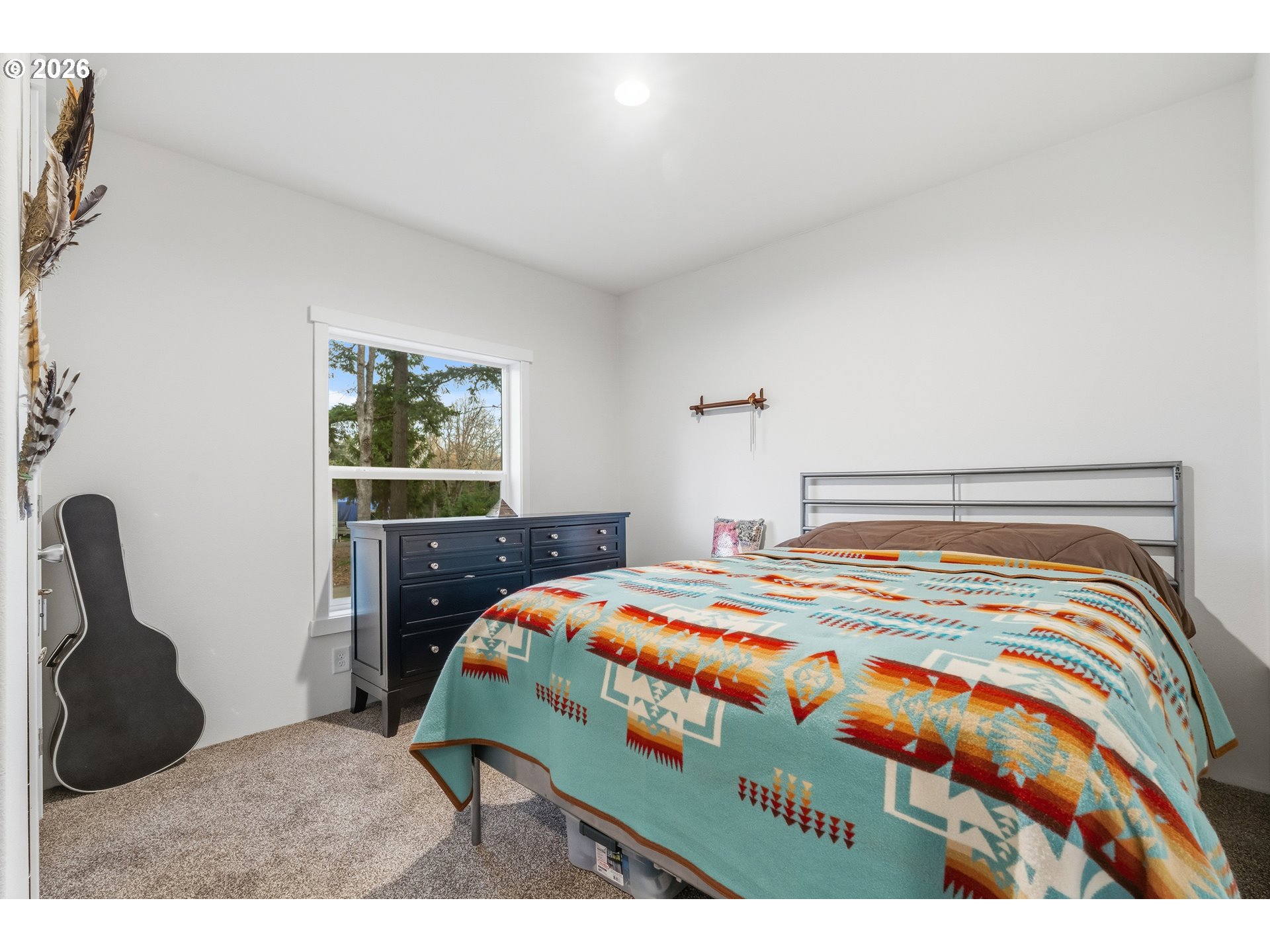 1390 Rockford Road Hood River, OR 97031 - Photo 7 of 14 a bedroom with a bed a painting and a lamp on the dresser
