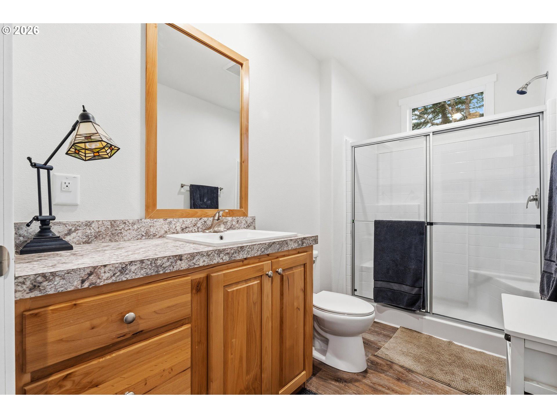 1390 Rockford Road Hood River, OR 97031 - Photo 8 of 14 a bathroom with a granite countertop sink toilet and shower