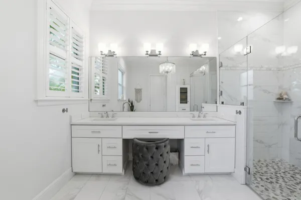 a spacious bathroom with a double vanity sink mirror and double