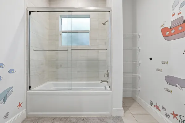 a bathroom with a bathtub and a shower