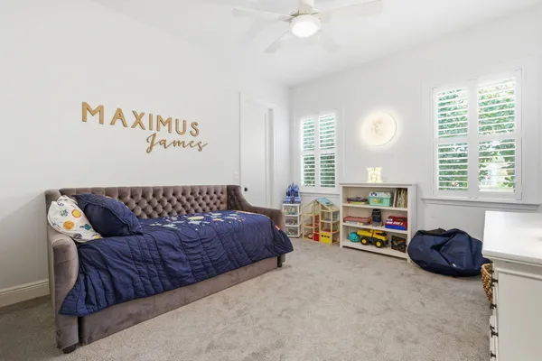 a living room with furniture a baby crib and a couch