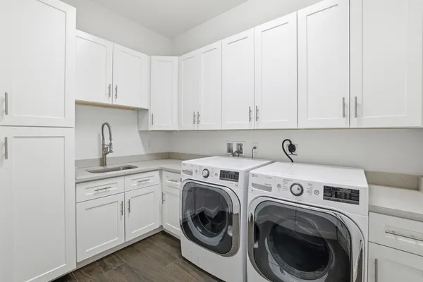 a utility room with sink dryer and washer