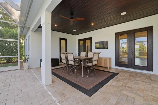 a dining room with granite countertop a table chairs and a chandelier