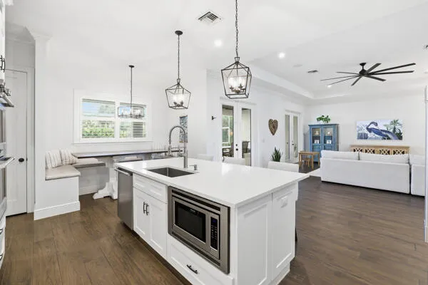 a kitchen that has a stove oven and a wooden floor