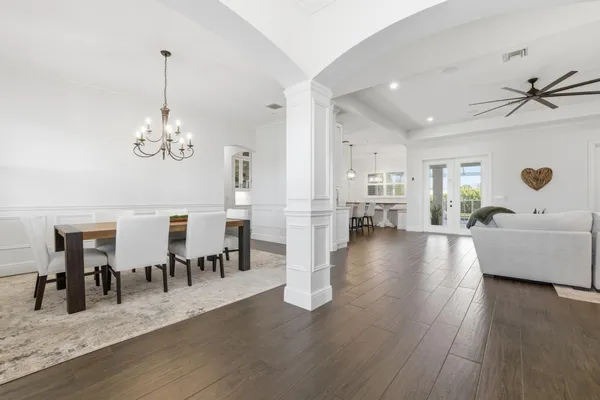 a view of a dining room with furniture and wooden floor
