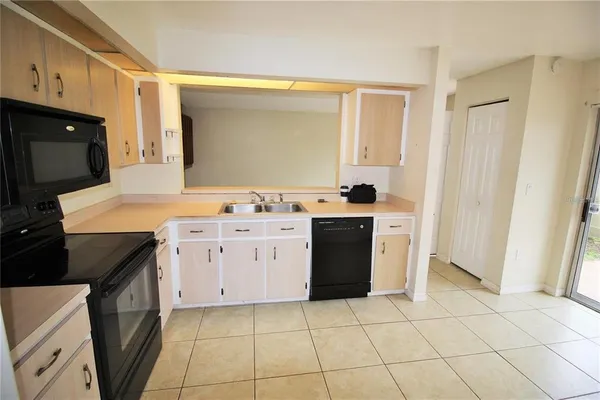 a kitchen with a sink a stove and a refrigerator