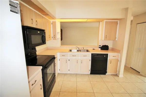a kitchen with a stove a sink and a refrigerator