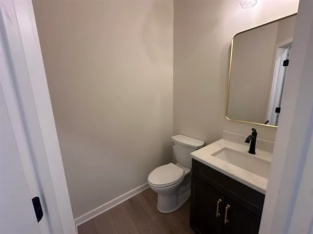 a white toilet sitting next to a bathroom sink