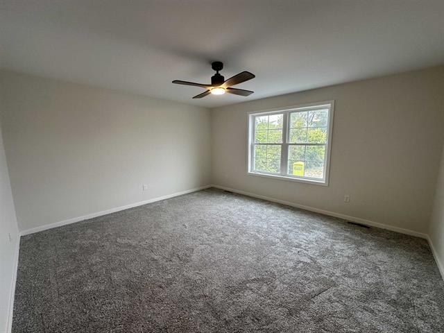 3156 South Bartells Drive Beloit, WI 53511 - Photo 16 of 33 an empty room with windows and chandelier fan