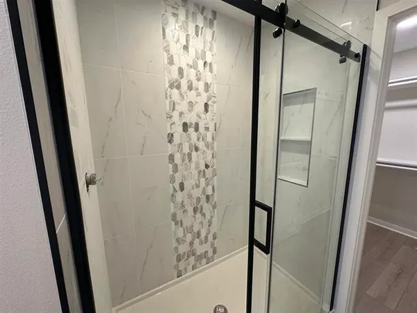 a bathroom with a shower and a mirror
