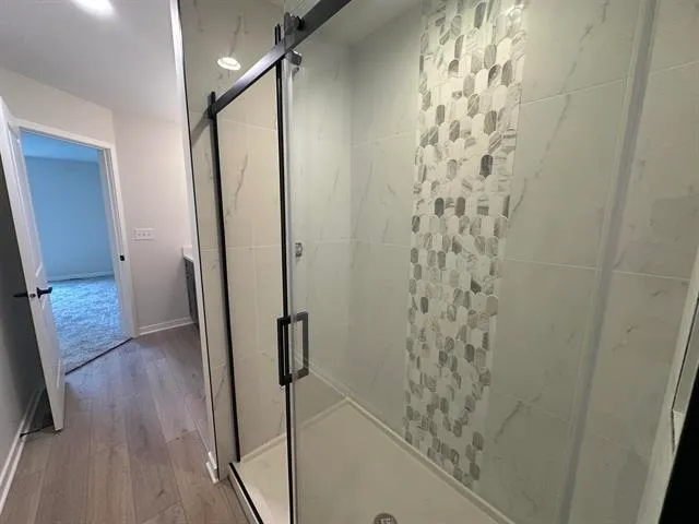 a bathroom with a shower and a mirror