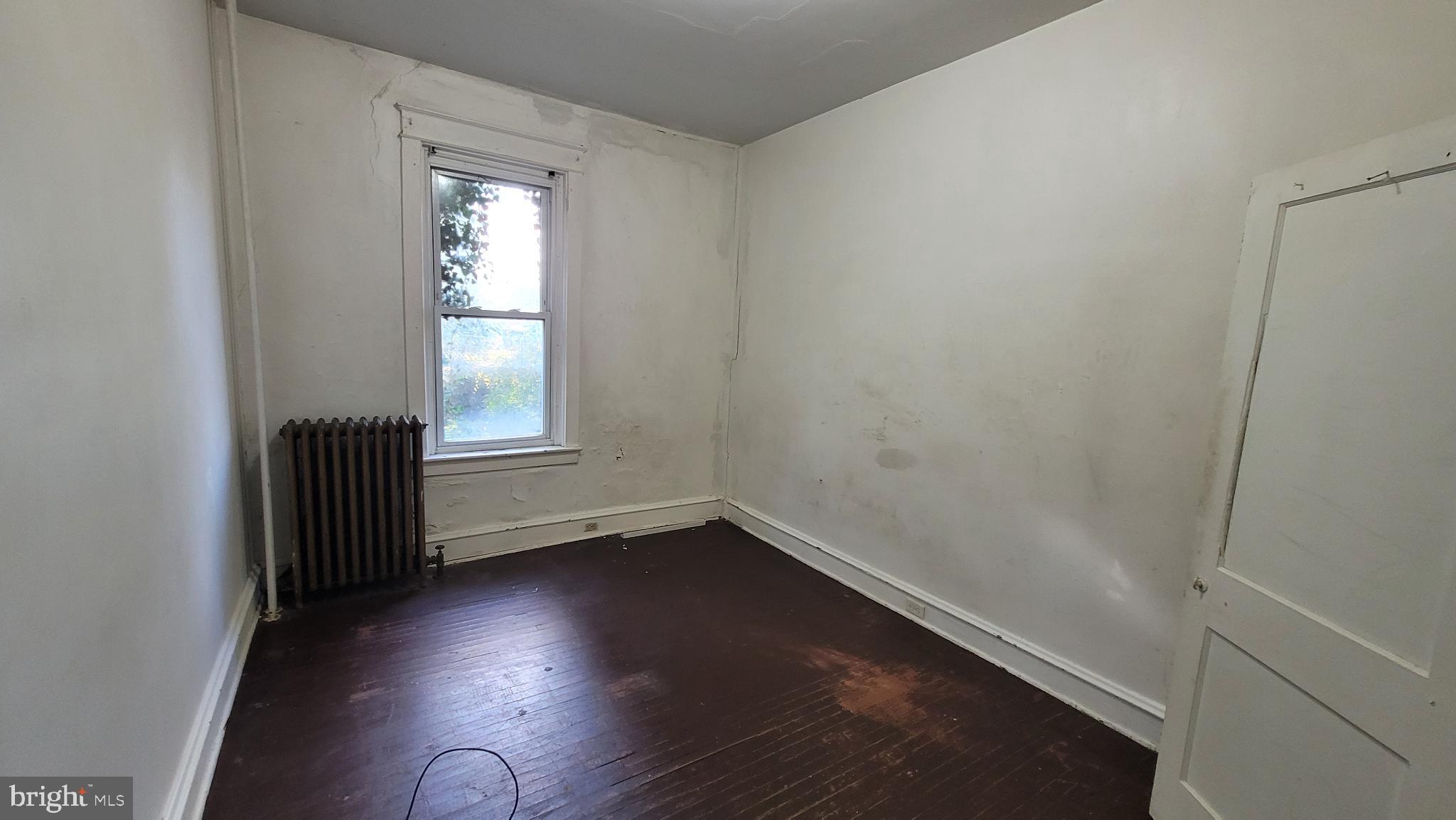 634 Centre Avenue, Unit 4 Reading, PA 19601 - Photo 13 of 20 an empty room with wooden floor and windows