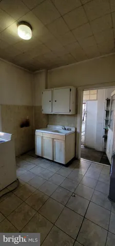 a kitchen with a sink a stove and cabinets