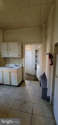 a view of a kitchen with cabinets and a refrigerator