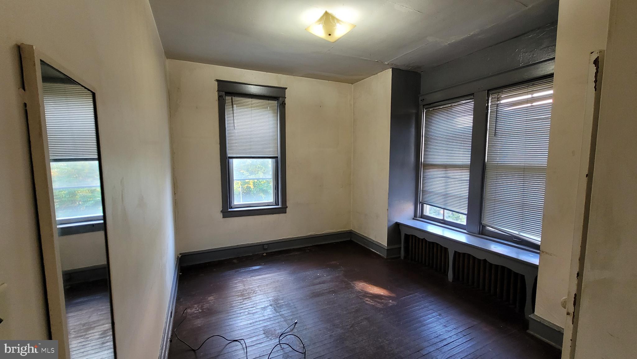 634 Centre Avenue, Unit 4 Reading, PA 19601 - Photo 9 of 20 an empty room with wooden floor and windows