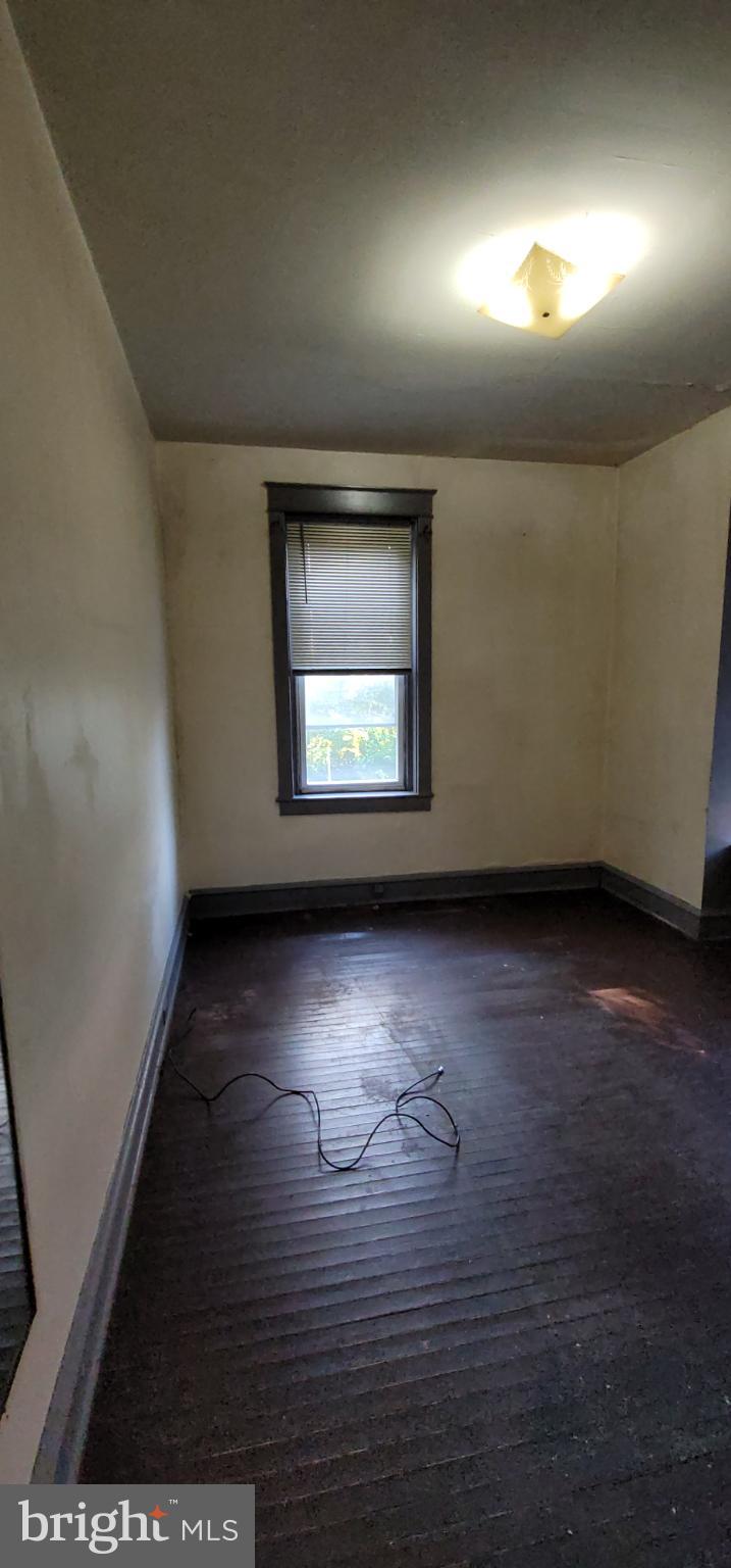634 Centre Avenue, Unit 4 Reading, PA 19601 - Photo 10 of 20 an empty room with wooden floor and windows