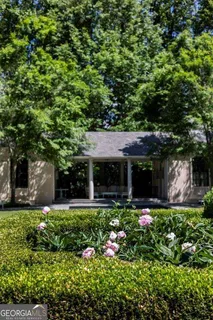 a view of a house with swimming pool and garden