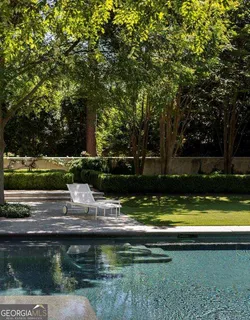 a view of house with swimming pool