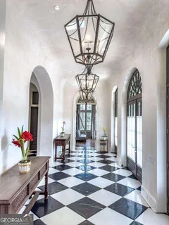 a view of a entrance door with a black and white checkered floor