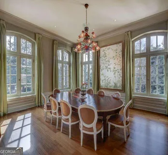 a living room with furniture fireplace and a large window