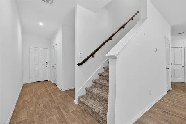 a view of entryway and hall with wooden floor