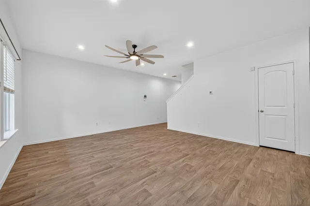 wooden floor in an empty room with a window