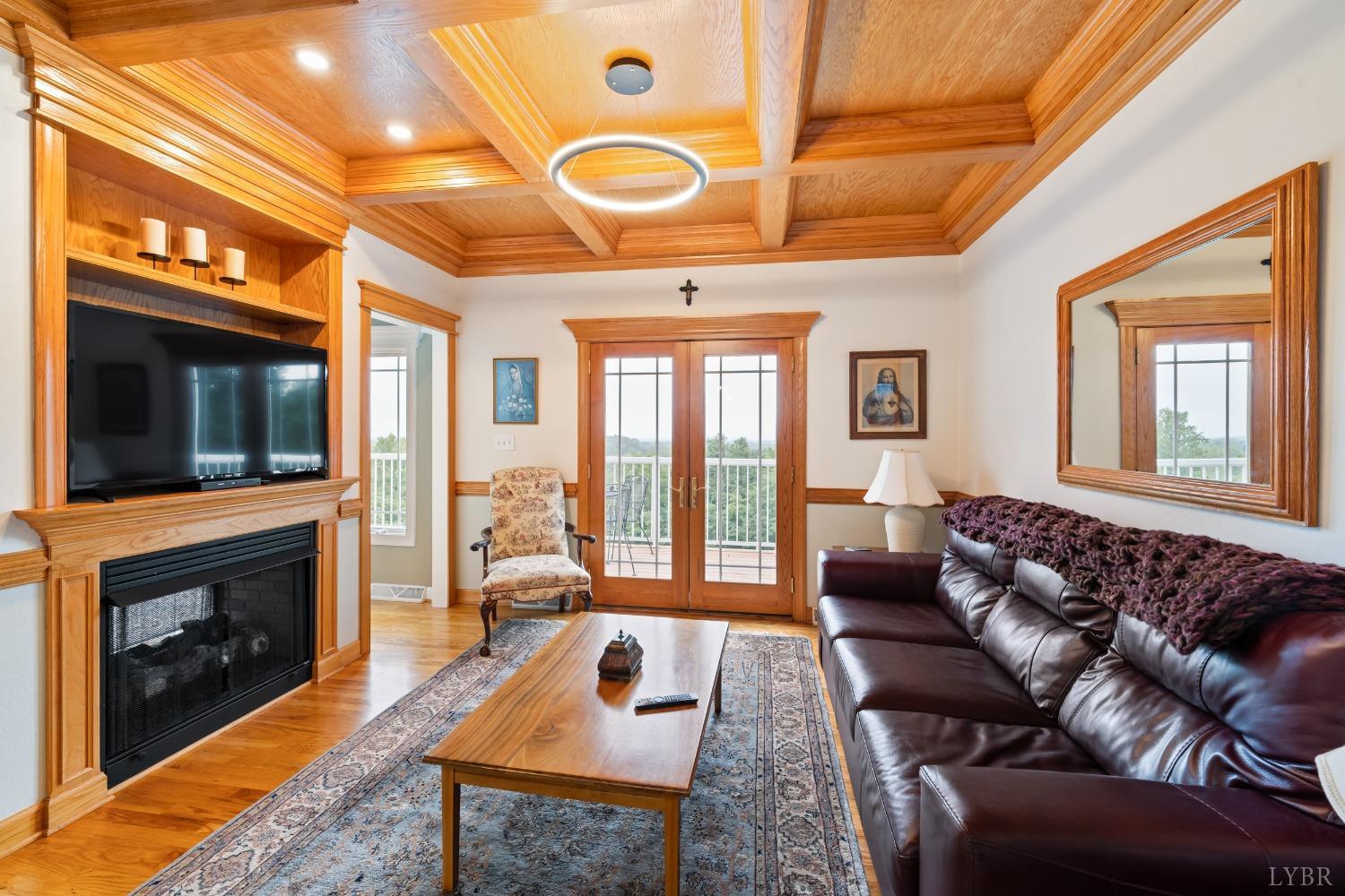 1136 Heavens View Drive Goode, VA 24556 - Photo 16 of 60 a living room with furniture a flat screen tv and a fireplace