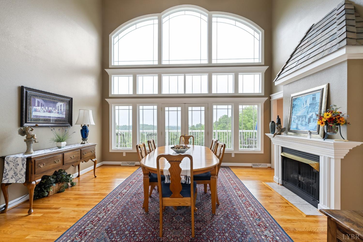 1136 Heavens View Drive Goode, VA 24556 - Photo 3 of 60 a living room with furniture a fireplace and large windows