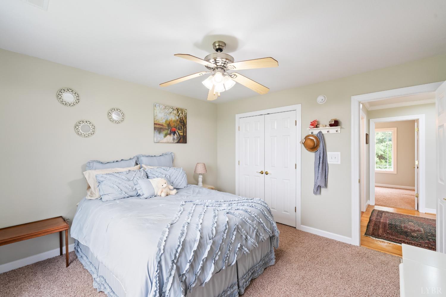 1136 Heavens View Drive Goode, VA 24556 - Photo 38 of 60 a bedroom with a bed and a chandelier