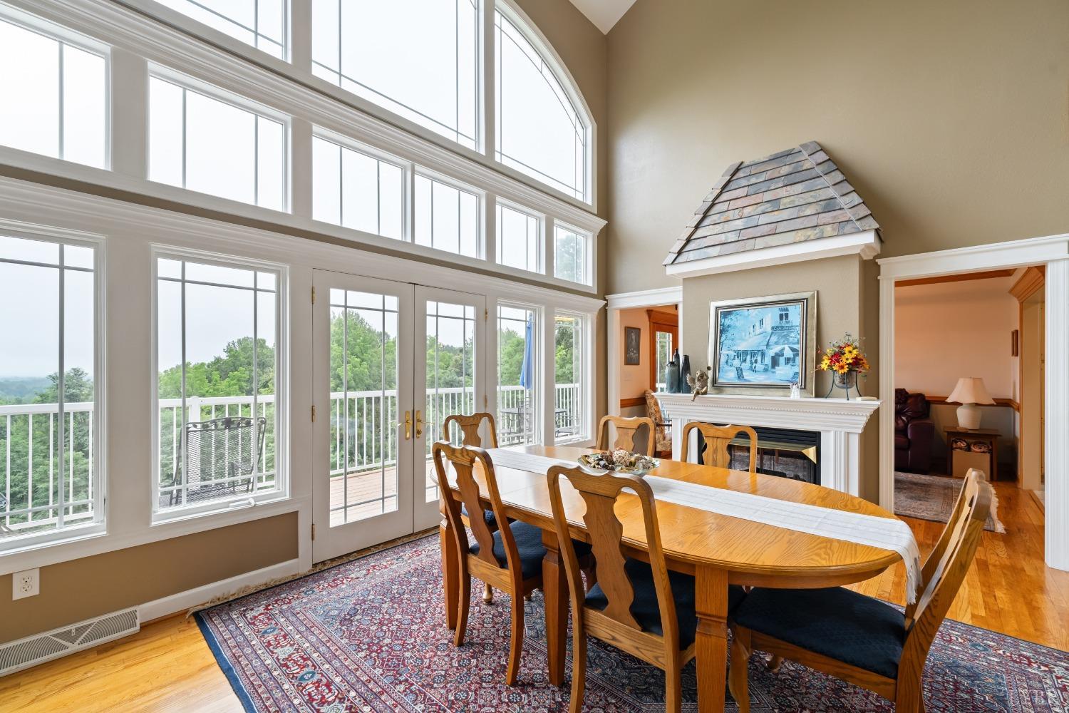 1136 Heavens View Drive Goode, VA 24556 - Photo 4 of 60 a dining room with furniture a rug and a floor to ceiling window