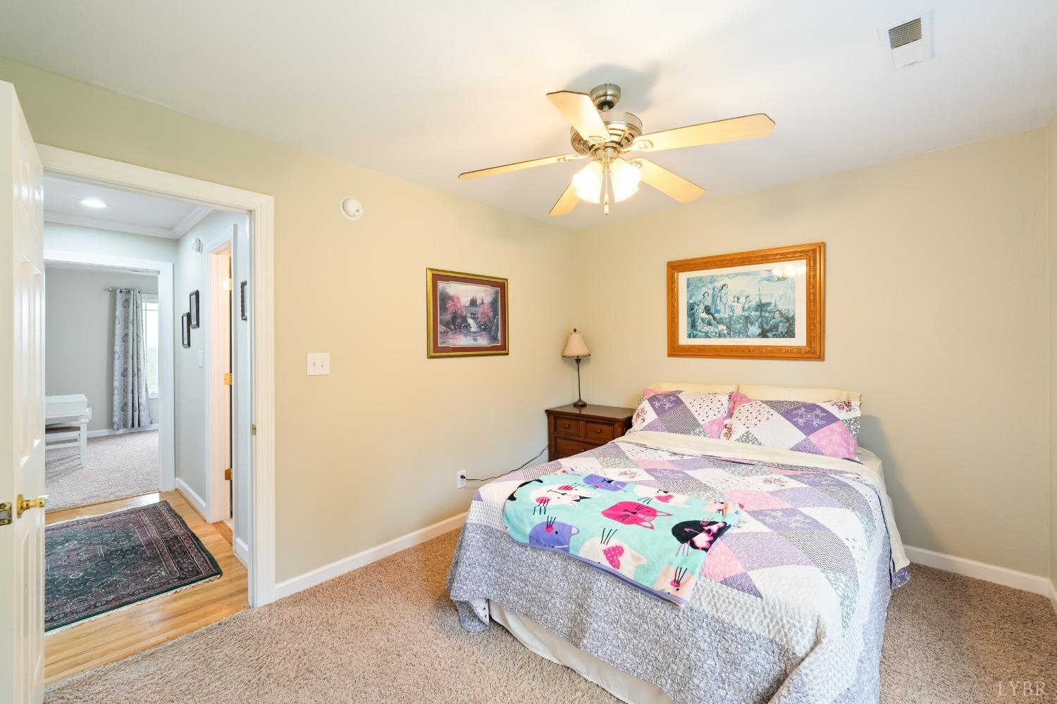 1136 Heavens View Drive Goode, VA 24556 - Photo 42 of 60 a bedroom with a bed and a painting on the wall