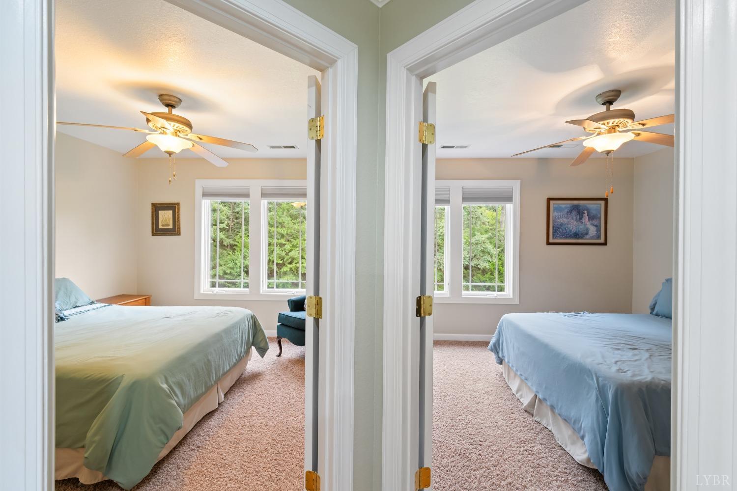 1136 Heavens View Drive Goode, VA 24556 - Photo 45 of 60 a bedroom with a bed and a chandelier