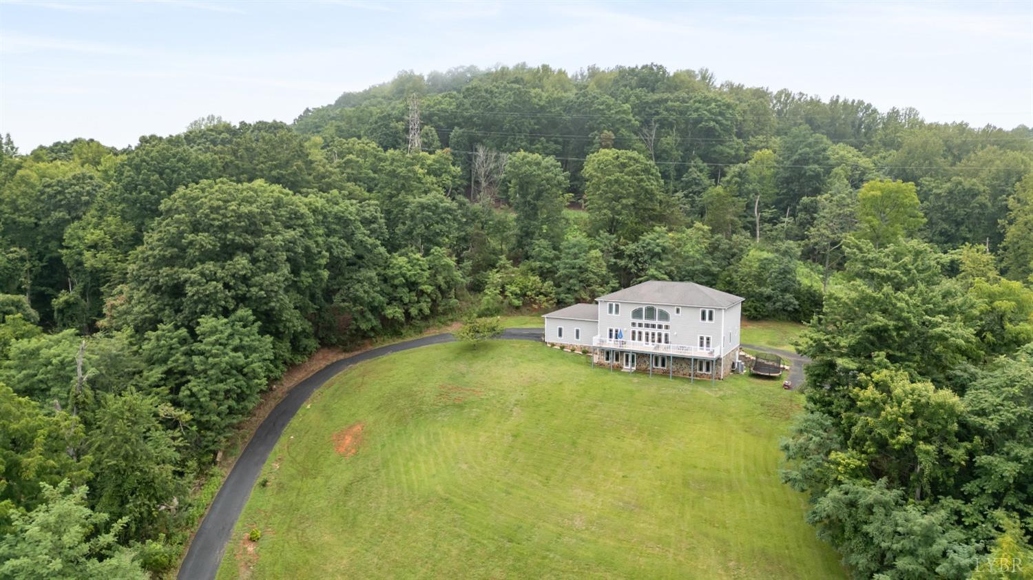 1136 Heavens View Drive Goode, VA 24556 - Photo 57 of 60 a view of a swimming pool with a yard and large trees