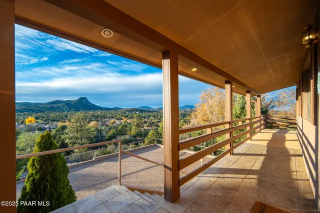 a view of a balcony with chairs and a table