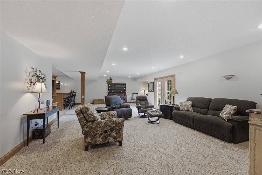 3955 Spring Brook Way Wooster, OH 44691 - Photo 35 of 50 Spacious lower-level area with recessed lighting, light-colored carpeting, French doors, and a built-in wet bar with pendant lighting