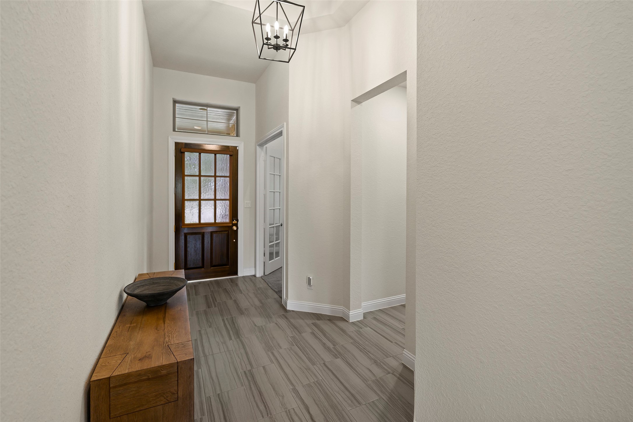 20330 Rosegold Way Spring, TX 77379 - Photo 35 of 48 Welcoming foyer featuring soaring ceilings, abundant natural light, and wood-look tile flooring.