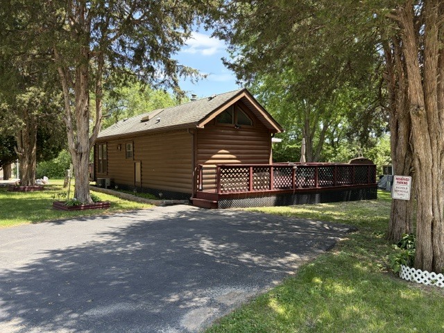 a view of a yard with a house and a large tree