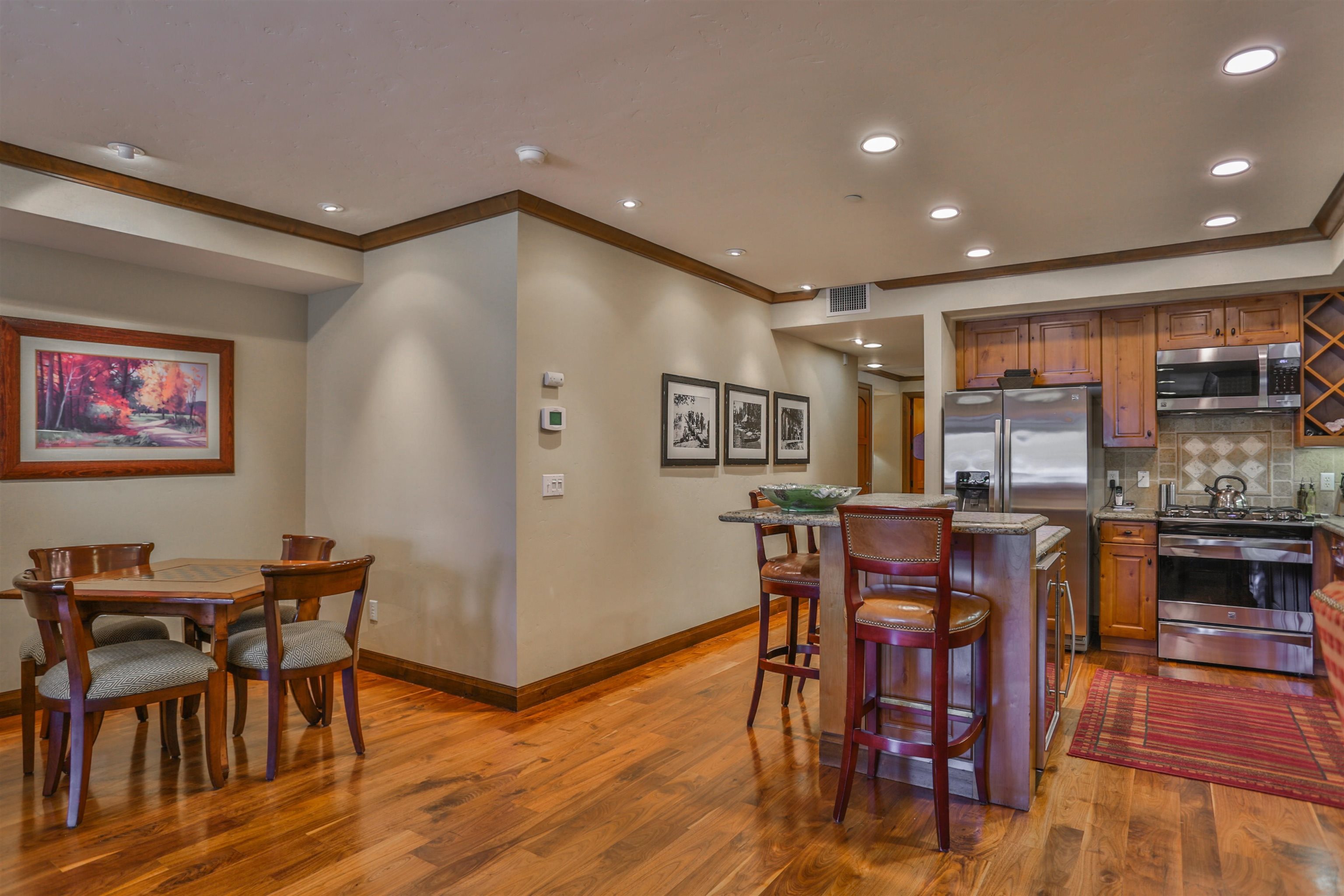 6750 North Lake Boulevard, Unit 3C Tahoe Vista, CA 96148 - Photo 13 of 22 a open kitchen with stainless steel appliances granite countertop a dining table chairs and granite counter tops