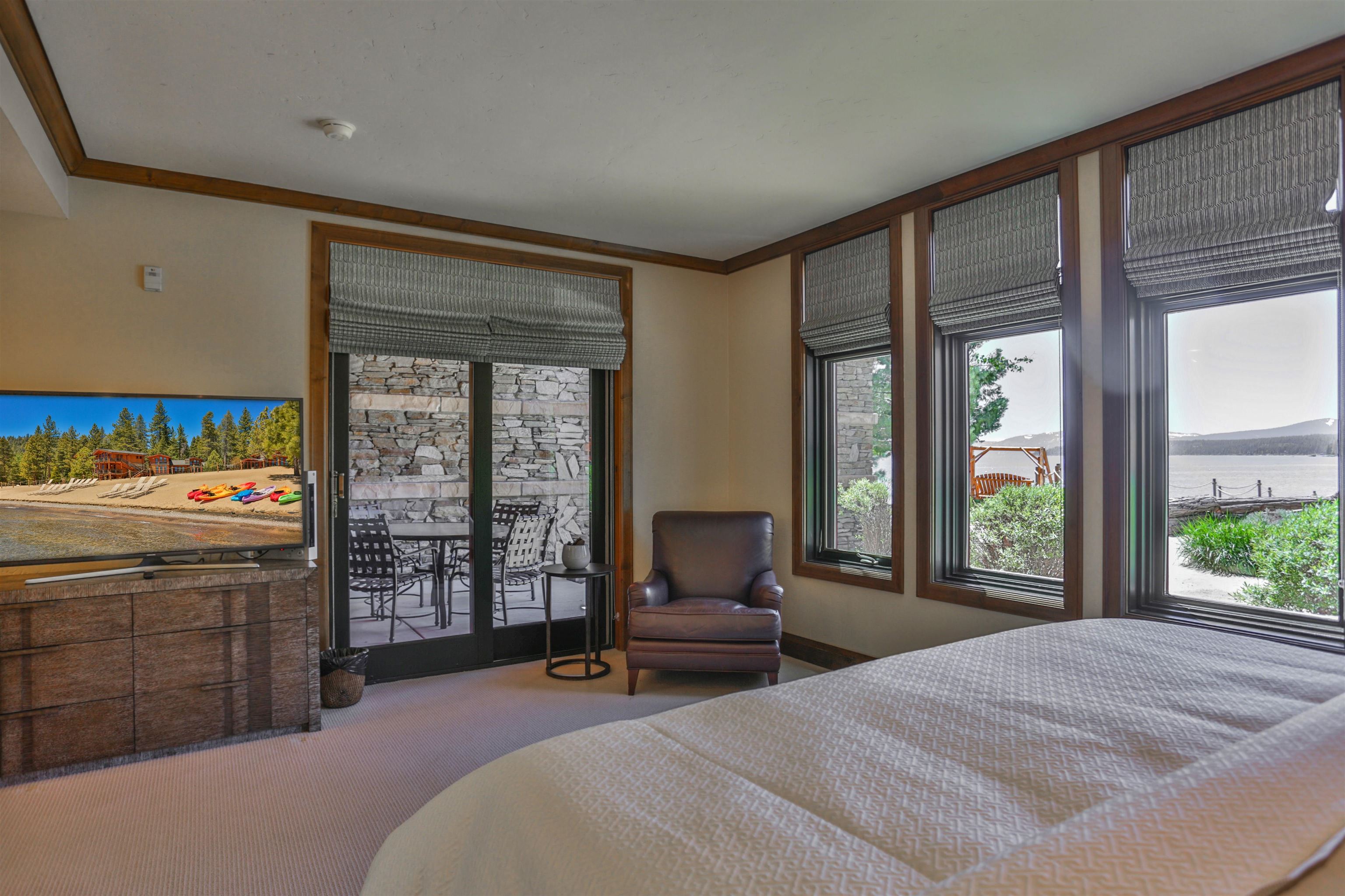 6750 North Lake Boulevard, Unit 3C Tahoe Vista, CA 96148 - Photo 5 of 22 a bedroom with a bed and large windows