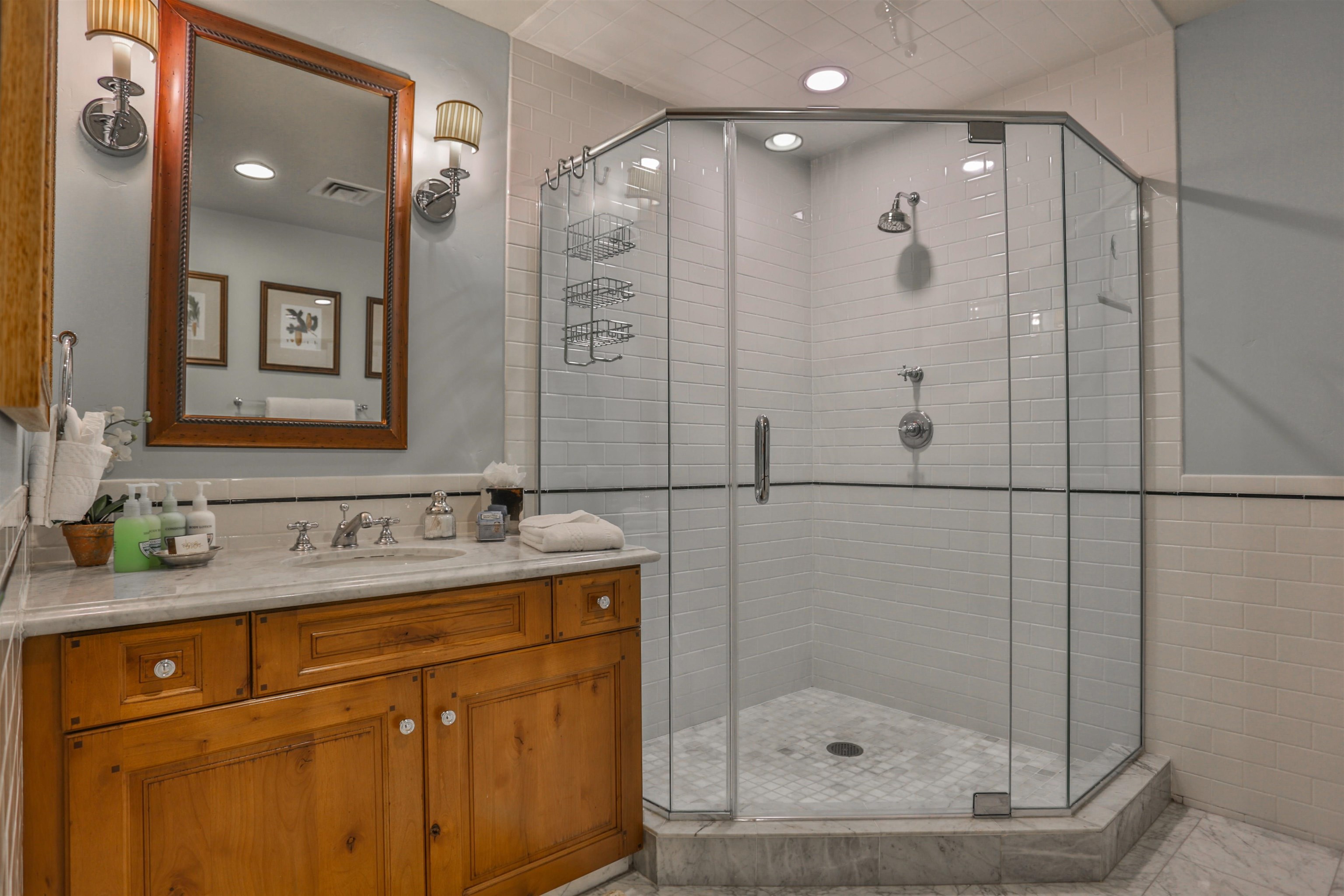 6750 North Lake Boulevard, Unit 3C Tahoe Vista, CA 96148 - Photo 9 of 22 a bathroom with a shower sink and mirror