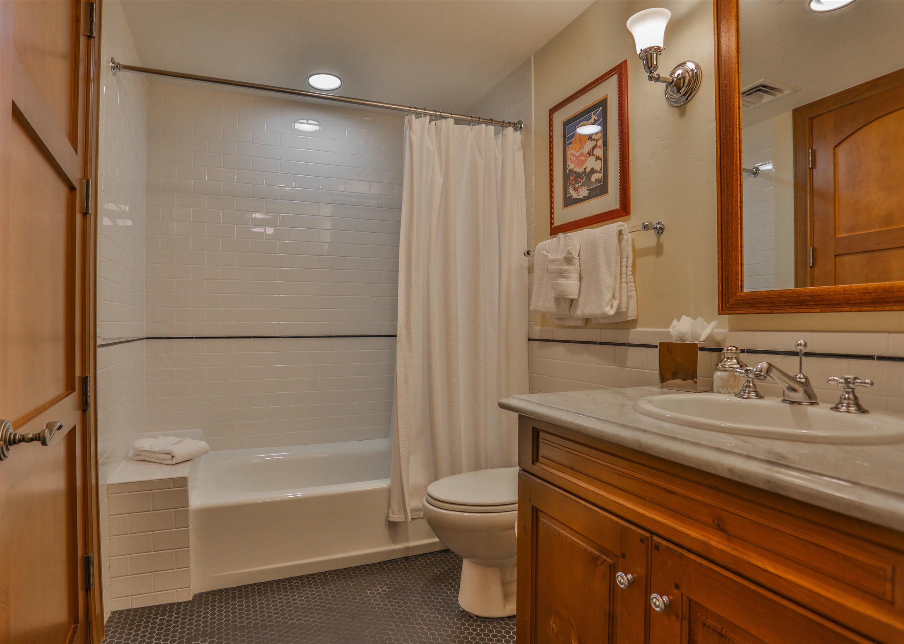 6750 North Lake Boulevard, Unit 3C Tahoe Vista, CA 96148 - Photo 10 of 22 a bathroom with a granite countertop sink toilet and shower