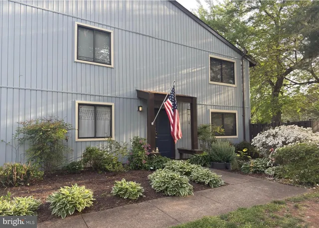 a view of a house with a yard and plants
