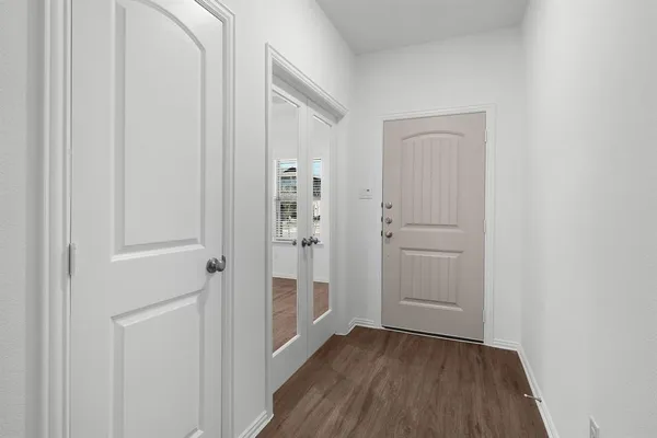 a view of a hallway with wooden floor