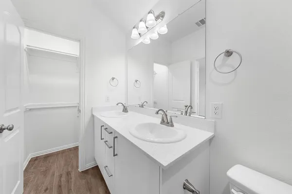 a bathroom with a sink vanity and a mirror