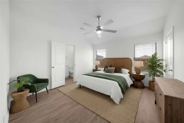a spacious bedroom with a bed and a chandelier