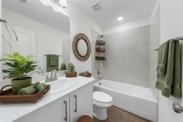 a bathroom with a double vanity sink and a bathtub
