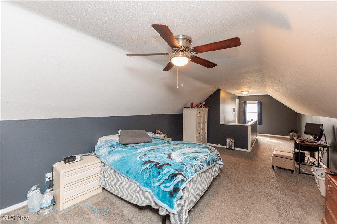 3443 Dentzler Road Parma, OH 44134 - Photo 36 of 48 Carpeted bedroom with a textured ceiling, lofted ceiling, and ceiling fan