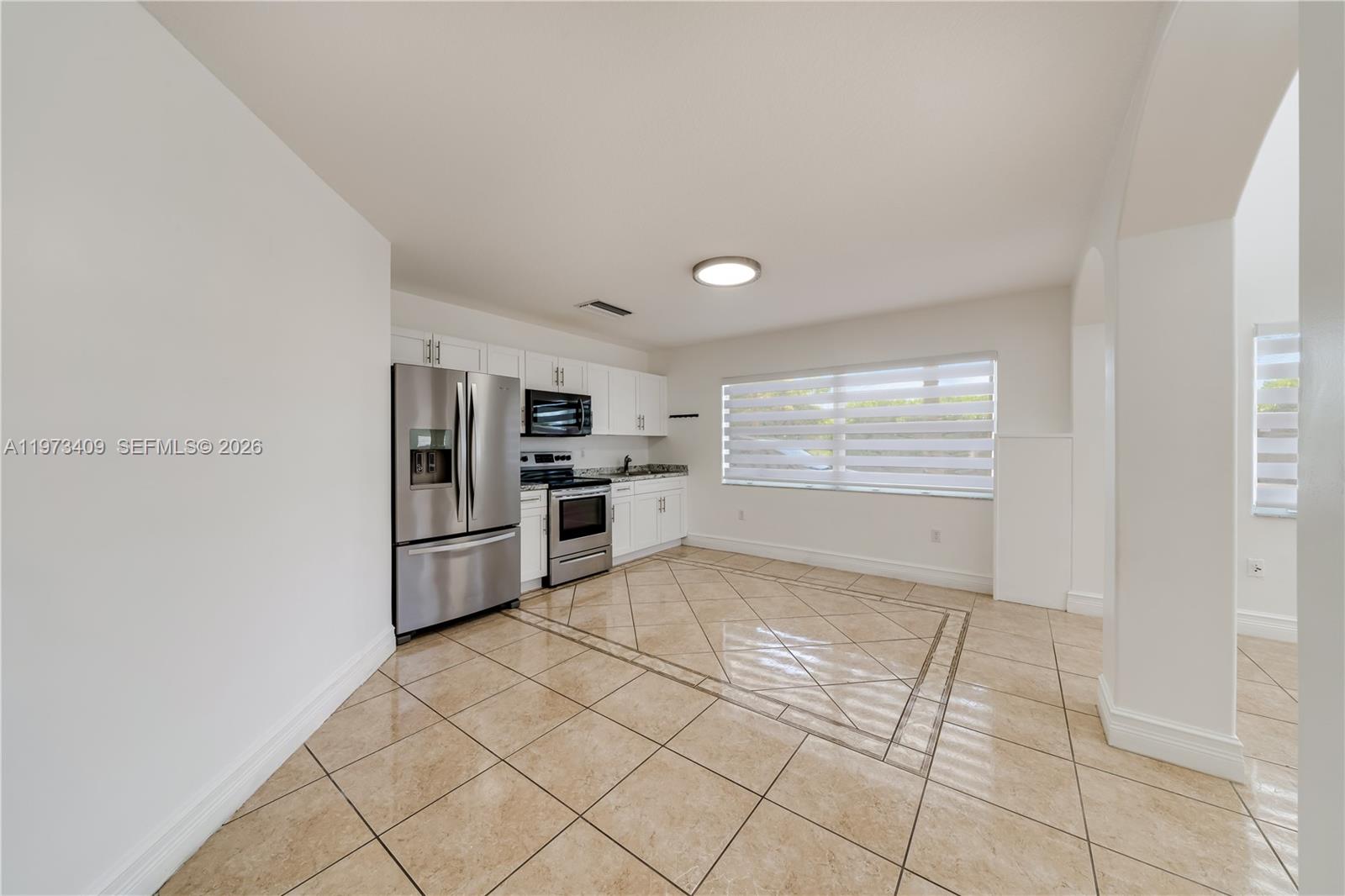 13050 Southwest 26th Street Miami, FL 33175 - Photo 14 of 43 a view of kitchen with refrigerator and window