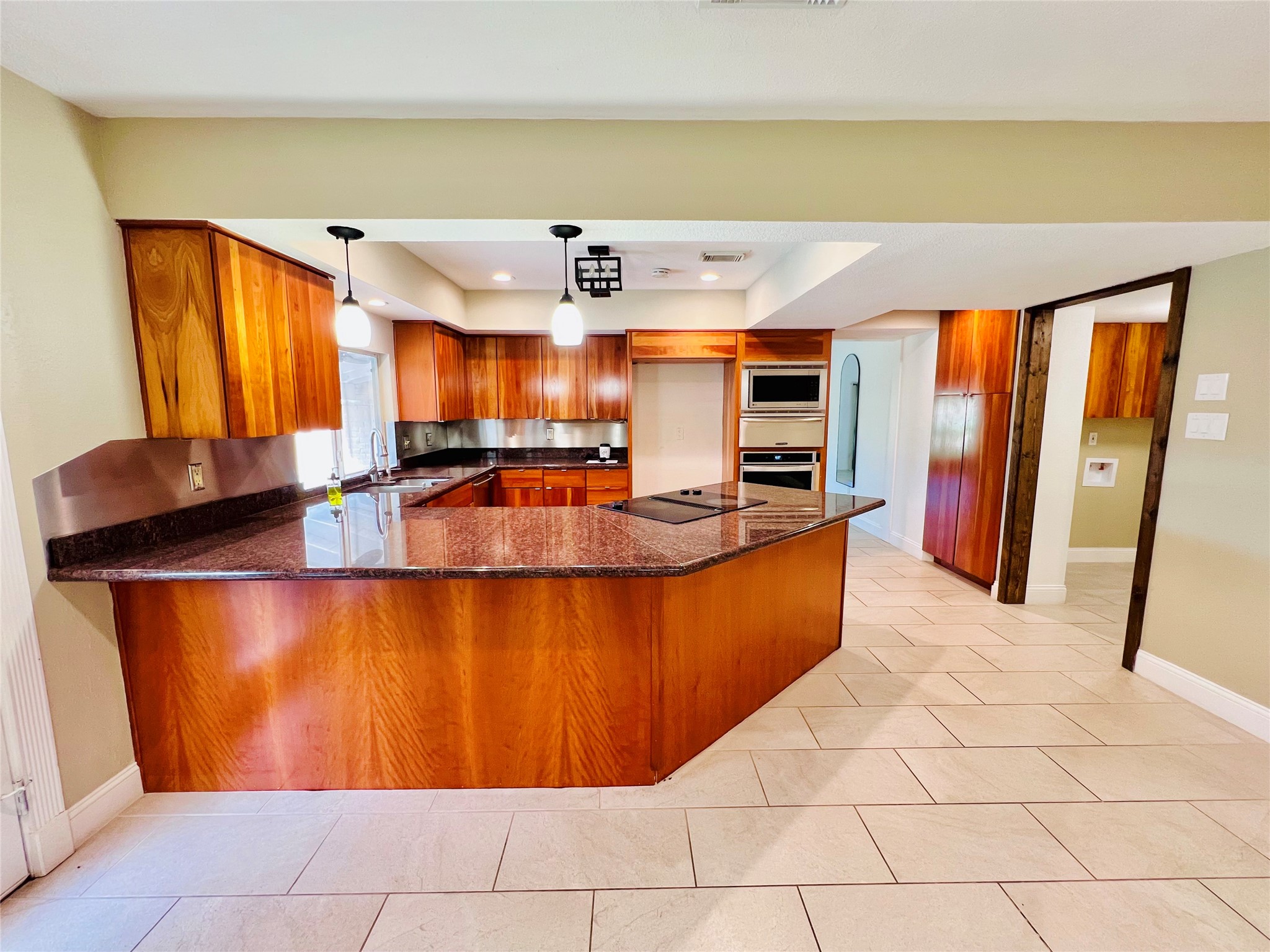 2602 Killdeer Lane Humble, TX 77396 - Photo 7 of 8 The heart of the home features striking cabinetery paired with granite counter tops, tiled floors, and modern stainless steel appliances.