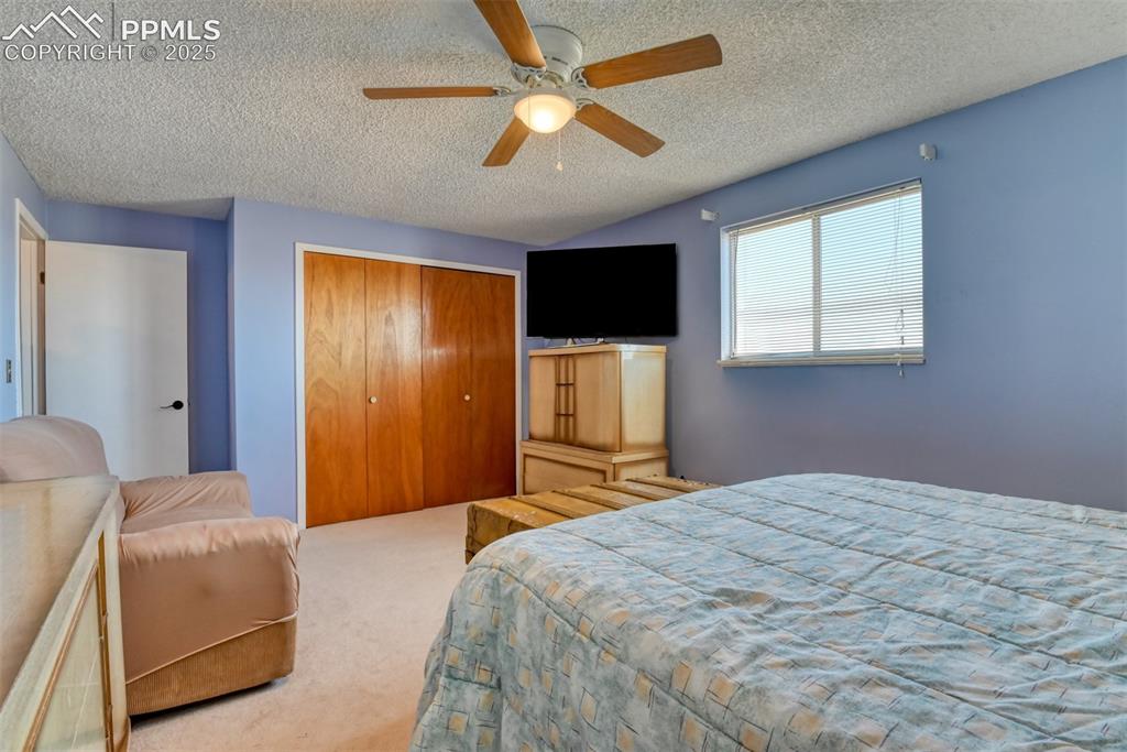 10970 Garrett Road Peyton, CO 80831 - Photo 31 of 50 a bedroom with a bed and a flat screen tv
